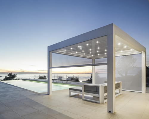 Pool and beach seating area covered with Bioclimatic Pergola